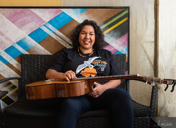 portrait of Jessie Lloyd with a guitar on her lap