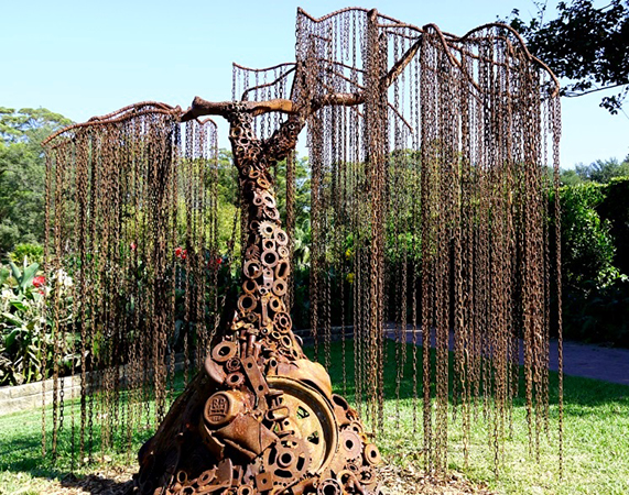Sculpture by Mike Tikkeros in the shape of a weeping willow tree made from rusted metal parts